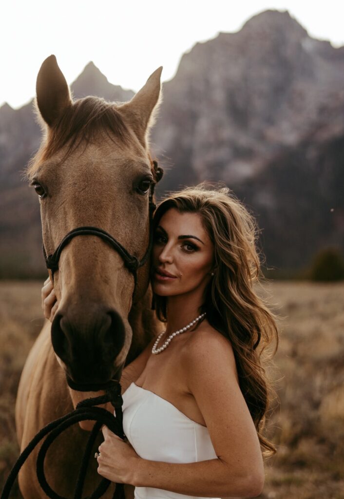 Beautiful bride with horse in the mountains, who had her beauty done by the premier Jackson Hole makeup artist team in the area.