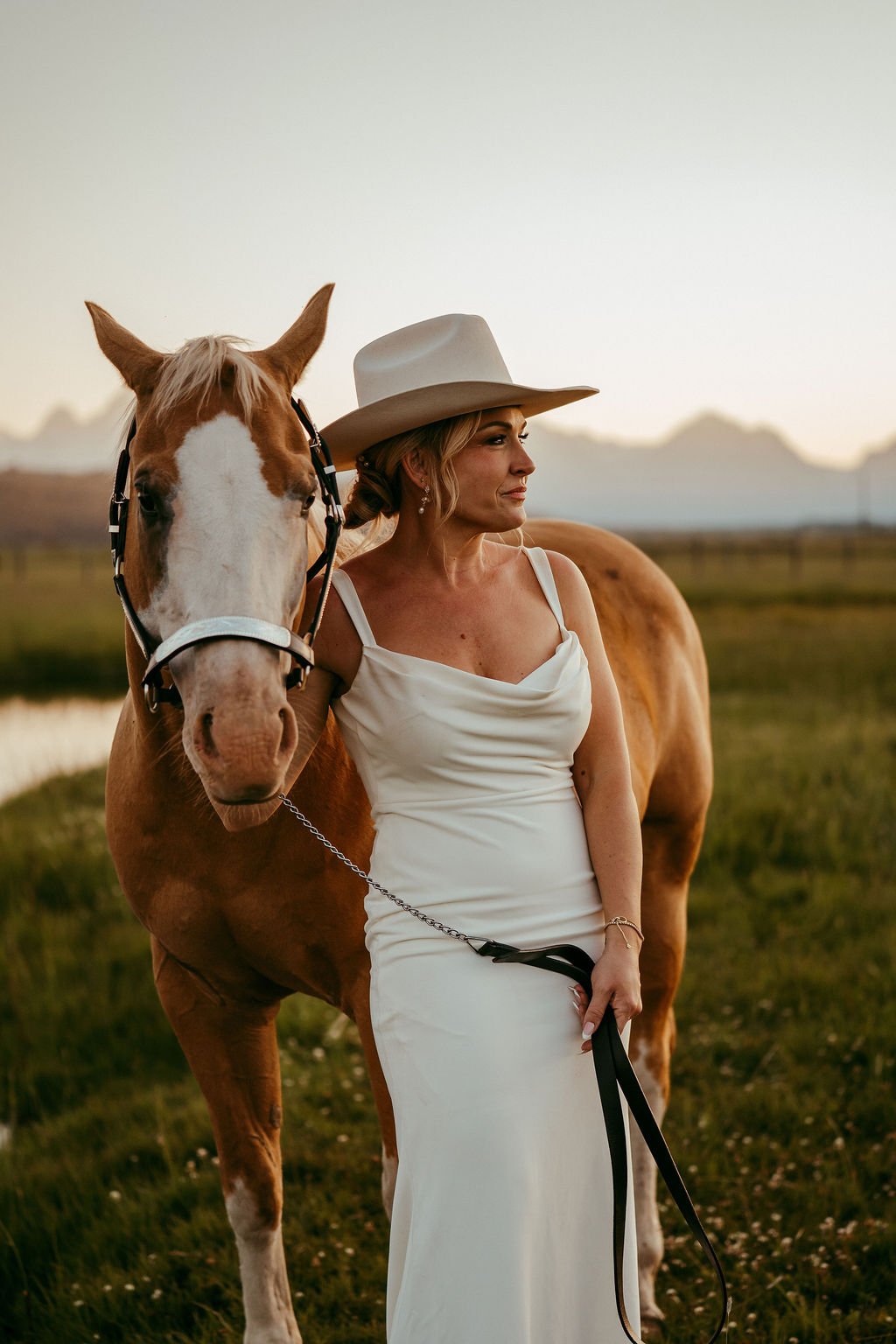 Bride with horse at golden hour with her bridal glow due to her Jackson Hole spray tan