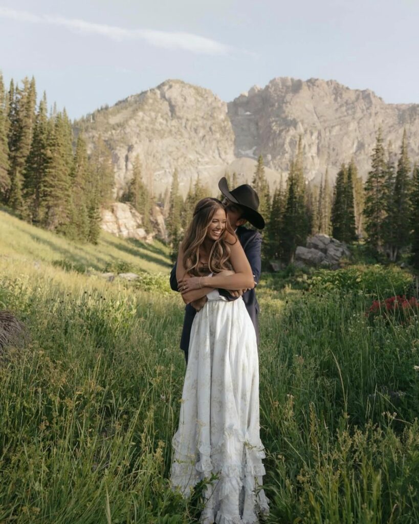 Newlyweds embracing in the mountain west